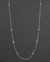 Stations of blue topaz shine on this elegant sterling silver necklace with 18K yellow gold accents. By Judith Ripka.