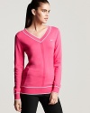 Sporty with a preppy twist, this Nike tennis sweater is chic both on and off the court.