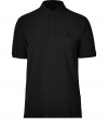 Casual yet sleek, Burberry Brits black cotton polo is cool way to dress up your laid-back looks - Classic collar, short sleeves, partial button-placket, tonal embroidered logo at chest, slit sides - Modern straight cut - Wear with your favorite jeans, a hoodie and sneakers