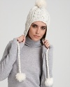 Keep cozy and look cool on the slopes or city streets in Eugenia Kim's cable-knit, pom pom accented cap.