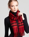 In soft cashmere, this luxe Burberry scarf boasts the brand's signature check print in a red palette with black and yellow accents.