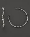 Undulating hoops resemble a handful of gleaming pebbles, sculpted in sterling silver. From the Kali collection.