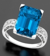 Turn heads with this brilliant ring featuring emerald-cut blue topaz (8-9/10 ct. t.w.) and round-cut diamond (1/8 ct. t.w.) set in 14k white gold.