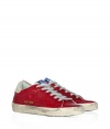 Modeled after vintage tennis shoes, this high-end version from Golden Goose will add an instant upgrade to your casual-cool style - Round suede toe, lace up front, leather upper with perforated side star detail, contrasting embossed leather logo detail, stylishly distressed rubber sole - Style with skinny jeans, a mini-skirt, or cut off denim shorts