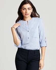 Spring's chambray trend arrives with this Vince shirt boasting a partial front placket and rounded hem. At back is a single pleat for a final touch of preppy chic.