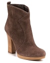 Earthy stacked heels take these rugged, western-inspired leather booties into high-style territory. By Enzo Agniolini.