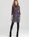 A paisley print in jewel tones brings enviable style to this Nanette Lepore dress with sheer, twisted neckline and sleeves.