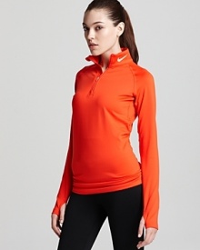 This cozy thermal Nike top features Therma-FIT fabric for keeping your core warm and Dri-FIT technology for superior moisture management.