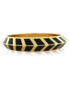 A pattern with panache. Vince Camuto's bangle bracelet is crafted from gold-tone mixed metal and black enamel with a bold chevron design for a stylish touch. Approximate diameter: 3-1/2 inches.