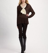 A long, easy V-neck sweater of pure mohair, in a lacy open stitch with suede elbow patches.Deep V ribbed neckline Long sleeves with suede elbow patches Longer in back About 25 from shoulder to hem Mohair Dry clean Imported