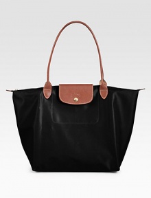 Lightweight nylon finished with rich leather trim, great for travel and everyday use.Double top handles, 8¼ dropTop zip and snap flap closureFolds up and snaps closedOne inside open pocket12¼W X 11¾H X 7½DImported