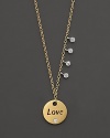 This gold medallion necklace is engraved with LOVE and accented by diamonds. Designed by Meira T.