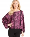 Vince Camuto combines a head-turning print with a knockout silhouette for this latest blouse.