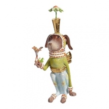 The Pointsittier by Patience Brewster draws his name from the white poinsettia blooms on his pants and the gold-leafed planter sitting on the pup's head. The Pointsittier by Patience Brewster draws his name from the white poinsettia blooms on his pants and the gold-leafed planter sitting on the pup's head.