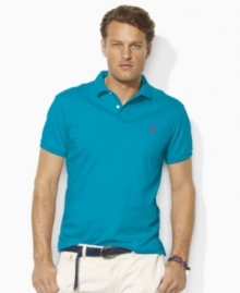 A classic short-sleeved polo shirt is cut for a trim, modern fit in smooth, soft cotton interlock.