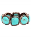 Nature's inspiration. Monet's earthy look combines reconstituted turquoise stones in a trendy bronze tone mixed metal setting. Bracelet stretches to fit wrist. Approximate diameter: 2-1/4 inches.