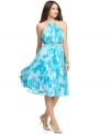 Calvin Klein's latest halter dress is a breath of fresh air with its bright print, belted waist and pleated silhouette.