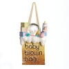 Celebrating someone's first holiday? There are few things more iconic than our Little Brown Bag. This one makes a great gift. Exquisitely crafted from glass and agglomerated stone, this bag is filled with baby baubles.