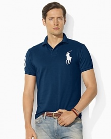 Cut in a trim, modern silhouette, a short-sleeved polo shirt is rendered in breathable cotton mesh with signature embroidery for iconic style. Cut in a trim, modern silhouette, a short-sleeved polo shirt is rendered in breathable cotton mesh with signature embroidery for iconic style.