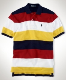 Rendered in breathable cotton mesh, a classic-fitting polo shirt is accented with bold stripes for a handsome, athletic look. Rendered in breathable cotton mesh, a classic-fitting polo shirt is accented with bold stripes for a handsome, athletic look.