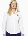 A crisp cotton poplin shirt is accented with rich heritage details, finished with an embroidered crest at the chest.