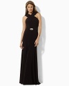 A crossed neckline and trumpeted skirt infuse a matte jersey gown with modern elegance.