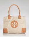 Uptown girls will love Tory Burch's metallic update of it's signature tote. In straw with tawny leather trims, it encapsulates casual chic.