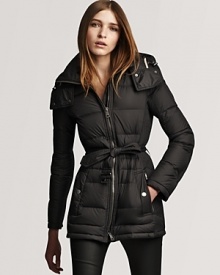 Keep out the cold with this luxe down puffer coat from Burberry Brit. Ribbed sides and a belted waist give figure-flattering form.