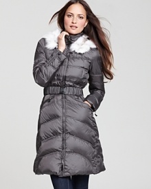 This essential Dawn Levy puffer coat gets a decadent lift with a removable fur-lined hood--a quick fix for an opulent winter look.