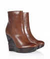 An edgy, sculptural wedge heel informs these ultra-versatile leather wedge booties from Diane von Furstenberg - Round toe, front platform, layered wooden wedge heel, ankle length, side zip closure, shiny leather - Pair with skinny jeans and an oversized pullover or with a printed mini-dress and ribbed tights