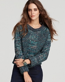 An all-time classic--the cable knit sweater--gets a fresh update articulated in a multicolor chunky knit.