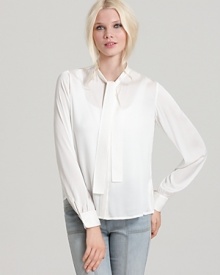 This Rachel Zoe silk blouse touts a chic tie collar and concealed front buttons, adding elegance to any look. Pair with a sharp pencil skirt and towering platforms to elicit your inner femme fatale. This Rachel Zoe silk blouse touts a chic tie collar and concealed front buttons, adding elegance to any look. Pair with a sharp pencil skirt and towering platforms to elicit your inner femme fatale.