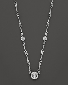 A white gold necklace has double-sided diamond stations; with signature ruby accent. Designed by Roberto Coin.