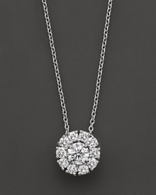 White gold diamond flower cluster pendant. With signature ruby accent. Designed by Roberto Coin.