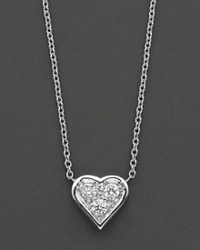 A delicate pendant diamond-encrusted heart necklace in 18 Kt. white gold, with signature ruby accent. Designed by Roberto Coin. A delicate pendant diamond-encrusted heart necklace in 18 Kt. white gold, with signature ruby accent. Designed by Roberto Coin.