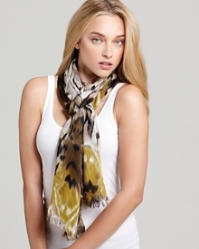 A bohemian oblong scarf with colorful ikat print and self fringe edges.