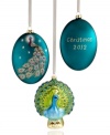 Peacock-theme beauty adorns your tree in these two ornaments, featuring intricate designs and shimmering sparkles. Oval ornament is shown front and back and reads: Christmas 2012.