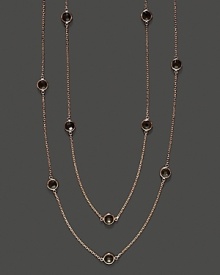Eighteen bezel set smoky quartz stations sparkle in a long, loopable 14K rose gold chain.