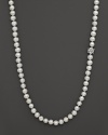 Pearl necklace finished with a white topaz and sterling silver flower ornament. By Anzie.