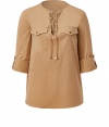 Safari-chic inspired and easy to style, this lace-up front top from Michael Kors is an elegant staple for off-duty or casual day-to-night style - Lace-up front, three-quarter sleeve with rolled button tab detail, chest flap pockets with buttons, back yoke with gather detail - Relaxed silhouette - Wear with sleek trousers or skinny jeans and platform heels