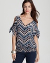 Fancy up your favorite jeans with this Akiko silk top, accented with chevron stripes and tie sleeves.