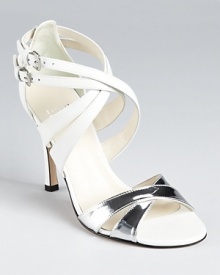 These strappy Stuart Weitzman sandals expertly mix icy white leather and gleaming metallic silver on a dazzling silhouette that gives a breath of fresh air to evening affairs.