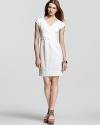 DKNY's trend-right white dress flatters the figure with a ladylike silhouette. Strappy wedges complete for summer-perfect style.
