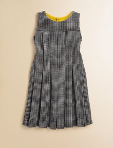 A retro, school-girl design in houndstooth goes modern with colorful piping at the neckline. Houndstooth patternRound neckline with contrast pipingSleevelessPleated bodice and skirtFit and flare silhouetteBack button closure50% fleece wool/50% viscoseMachine washMade in Italy A retro, school-girl design in houndstooth goes modern with colorful piping at the neckline. Houndstooth patternRound neckline with contrast pipingSleevelessPleated bodice and skirtFit and flare silhouetteBack button closure50% fleece wool/50% viscoseMachine washMade in Italy