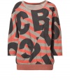 Logo-detailed and ultra-cool, this bold sweatshirt from Marc by Marc Jacobs adds a stylish jolt to your casual look - Round neck, three-quarter sleeves, boxy silhouette, asymmetric seam, allover logo and stripe print, banded hem - Wear with leggings or skinny jeans and embellished ballet flats