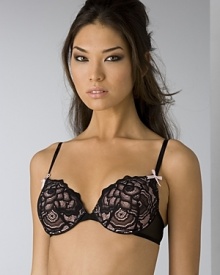 A padded bra with rose lace detail and bow detail at adjustable straps. Hook and eye closure.