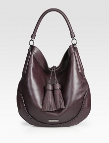 A mix of smooth and pebbled leather with beautiful stitched details throughout and two large tassel embellishments.Top handle, 5 dropMagnetic snap closureOne inside zip pocketTwo inside open pocketsCotton lining14W X 13¼H X 2DImported A mix of smooth and pebbled leather with beautiful stitched details throughout and two large tassel embellishments.Top handle, 5 dropMagnetic snap closureOne inside zip pocketTwo inside open pocketsCotton lining14W X 13¼H X 2DImported