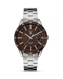 TAG Heuer's Carrera series has epitomized racing style since its introduction nearly 50 years ago. This watch features a Calibre 5 automatic movement with an expanded date window at three o'clock. The brown dial features a Clous de Paris textured design with a matching brown aluminum bezel. The 39mm steel case is mated to a steel bracelet with alternating fine-brushed and polished steel elements. TAG Heuer's Carrera series has epitomized racing style since its introduction nearly 50 years ago. This watch features a Calibre 5 automatic movement with an expanded date window at three o'clock. The brown dial features a Clous de Paris textured design with a matching brown aluminum bezel. The 39mm steel case is mated to a steel bracelet with alternating fine-brushed and polished steel elements.