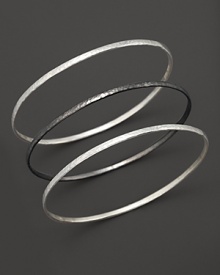 Two striking tones, three beautiful bangles from Gurhan, crafted in hammered white silver and dark silver.