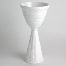 Judaica is a twist on the best selling Louvre pattern from Bernardaud. Pieces from this collection make perfect gifts for the holidays or for the couple who treasures their heritage. The Bernardaud service was engraved by hand, following the grand tradition of master sculptors. Casual or formal, the collection expresses a unique personality of quality craftsmanship. Available pieces include: set of 6 mini seder plates; kiddush cup; matzah plate; mezuzah; rice bowl; and seder plate. The set of 6 mini seder plates are sold separately from the seder plate. Judaica is a twist on the best selling Louvre pattern from Bernardaud. Pieces from this collection make perfect gifts for the holidays or for the couple who treasures their heritage. The Bernardaud service was engraved by hand, following the grand tradition of master sculptors. Casual or formal, the collection expresses a unique personality of quality craftsmanship. Available pieces include: set of 6 mini seder plates; kiddush cup; matzah plate; mezuzah; rice bowl; and seder plate. The set of 6 mini seder plates are sold separately from the seder plate.